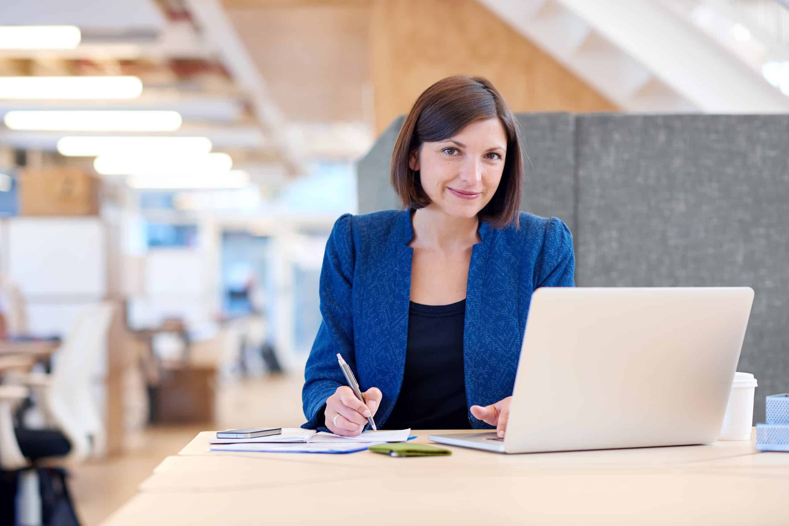 woman with blue jacket using laptop