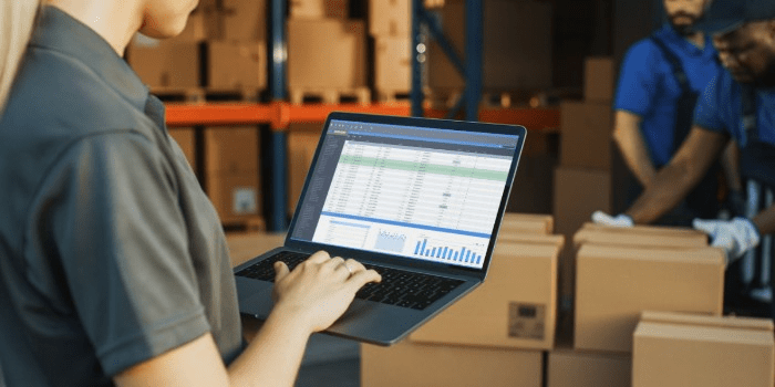 reviewing warehouse reporting on a laptop