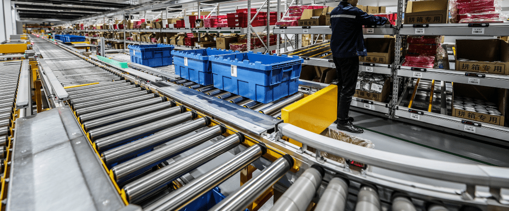 warehouse worker picking orders using a conveyor